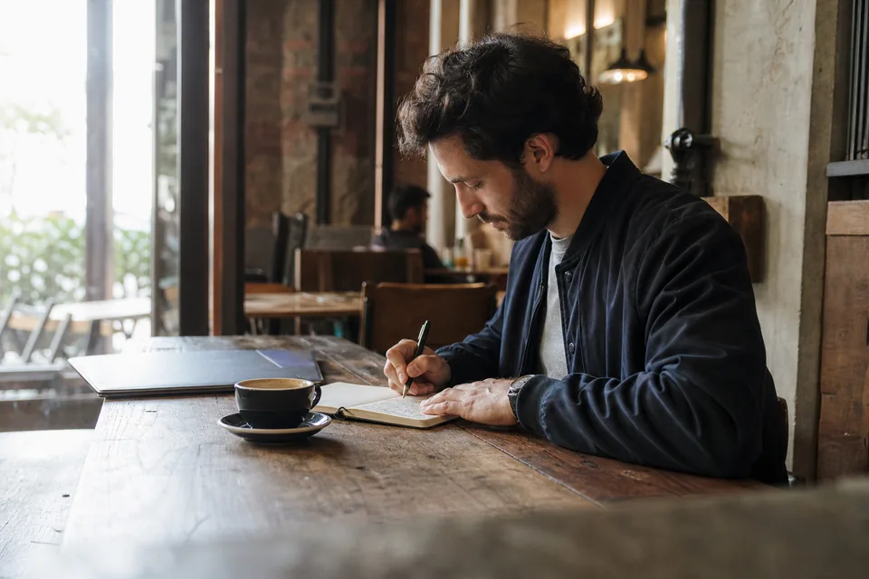 Founder writing notes on goods and services next to product samples