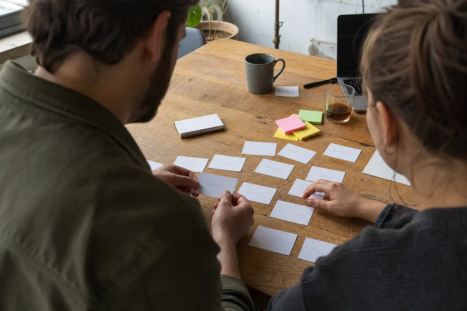 Team comparing a shortlist of brand name cards on a table